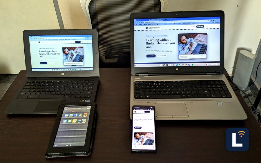 The Lory Online School site shown on laptops, a tablet, and a phone